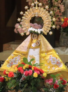 devotional statue of Our Lady of Penafrancia, crowned with and surrounded by flowers